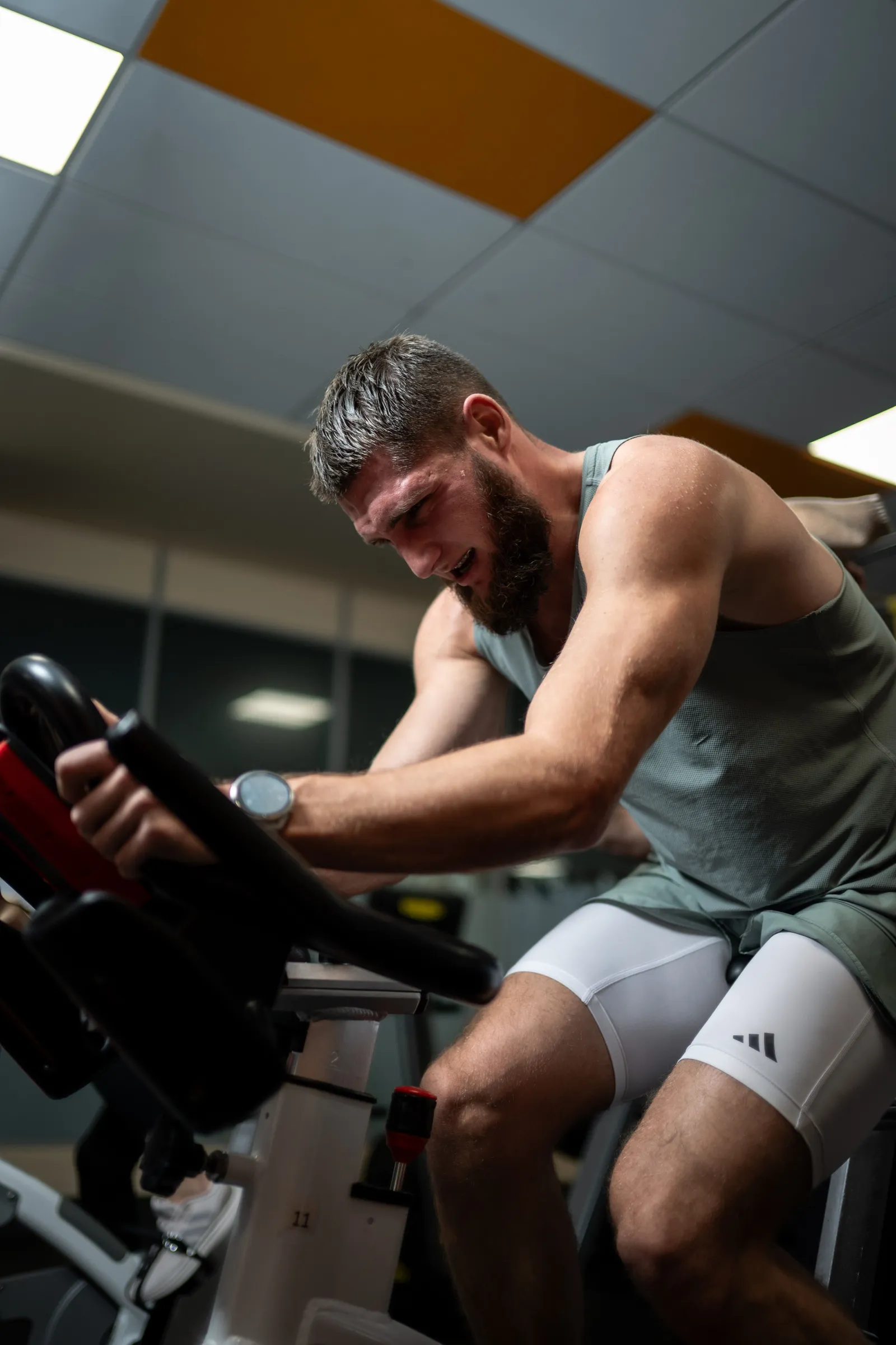 A rider focused mid-effort on a stationary bike