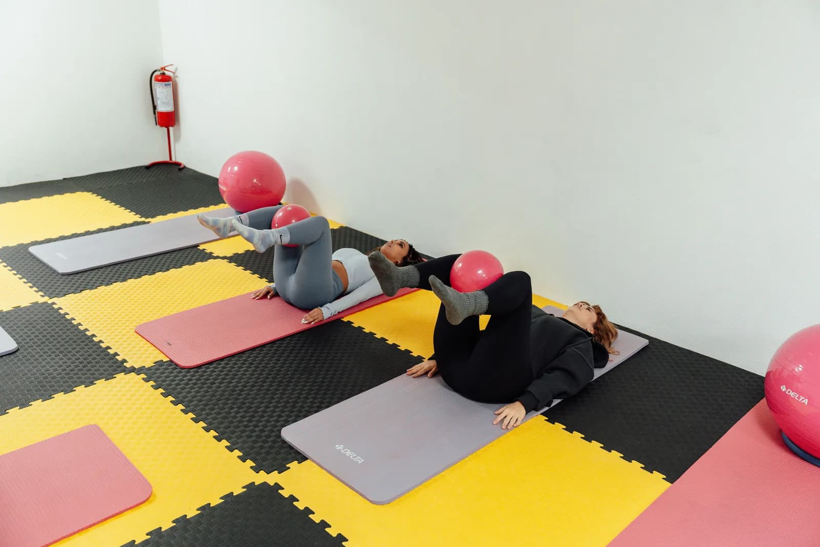 Members on mats during a Pilates class